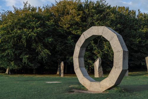 Free Majestic stone circle in a lush forest clearing during daylight near Warminster. Stock Photo