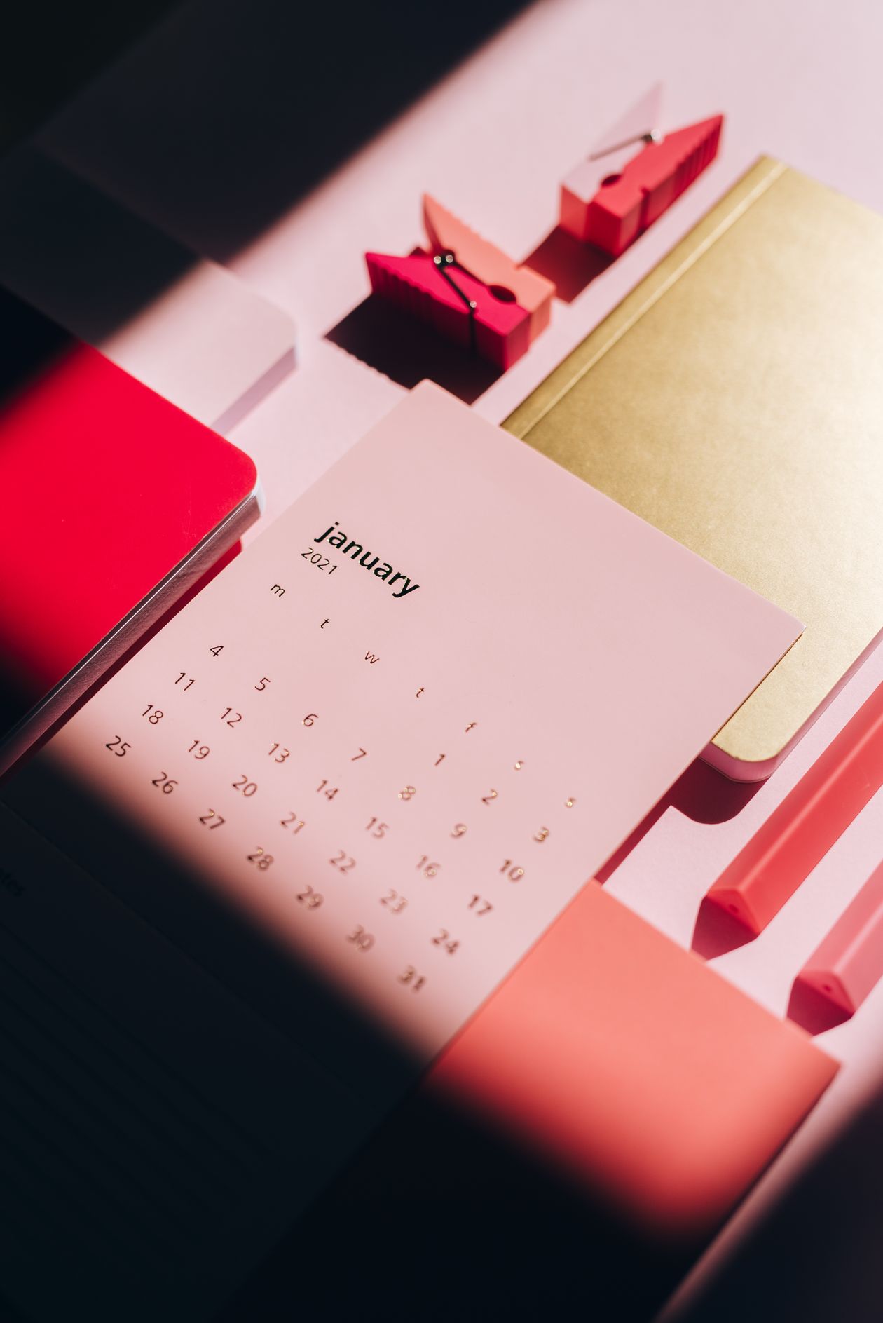 Multicolored notebooks and calendar for planning a first UpViral referral campaign
