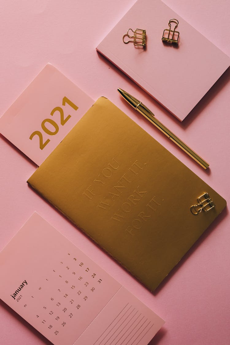 Notebook, Pen And Calendar On Pink Background