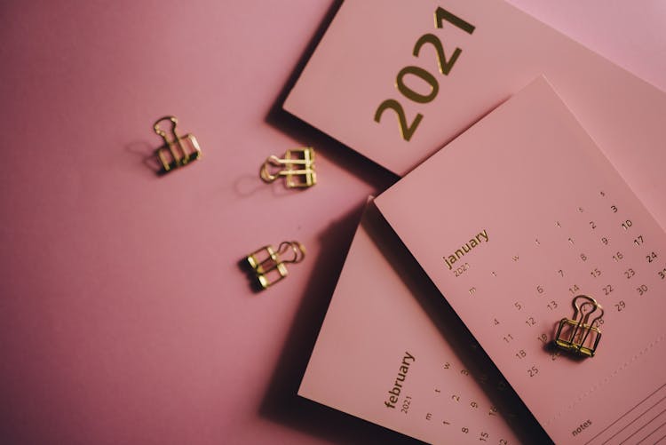 Set Of Contemporary Calendars And Clips On Pink Background