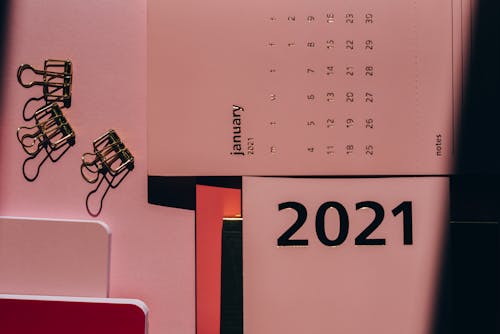Free Overhead view of contemporary calendar with weekly dates near metal clips on office desk Stock Photo