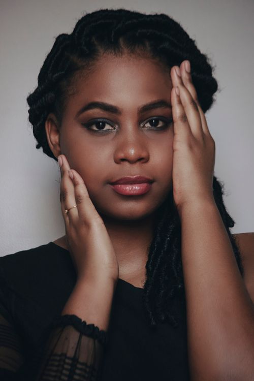 Free Stunning close-up of a woman's face with elegant makeup and braided hair. Stock Photo