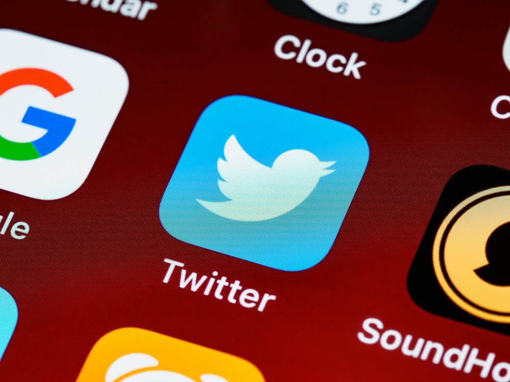 An image of an iphone home screen with the Twitter logo in the centre. 