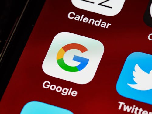 Free Macro view of a smartphone displaying Google and other app icons on the home screen. Stock Photo