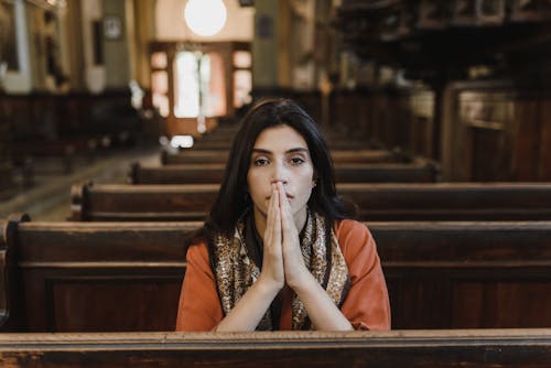 Woman Praying Inside Church