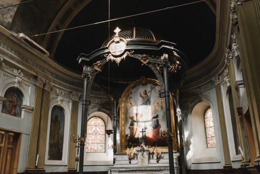 Beautiful interior of an orthodox cathedral featuring ornate dome and religious paintings.