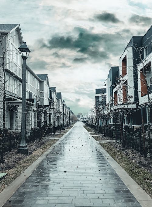 Free Clouds and Rain over Buildings and Alley Stock Photo