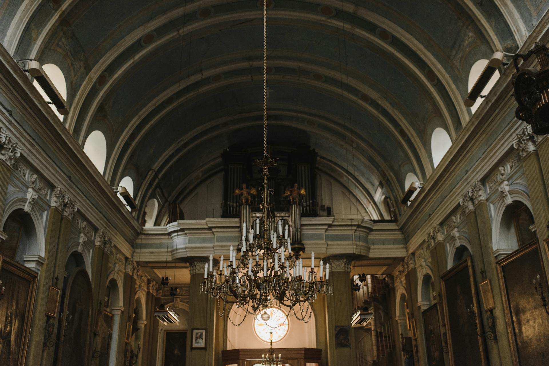 Captivating view of a classical church interior highlighting an ornate chandelier and architectural arches.