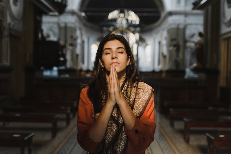 Woman Praying Inside The Church