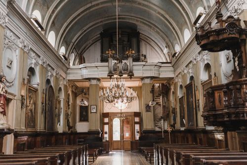 Free Explore the ornate interior of an ancient cathedral with chandeliers and statues. Stock Photo