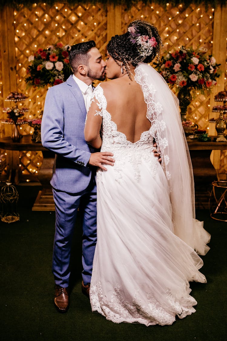 Young Newlywed Couple Kissing During Wedding