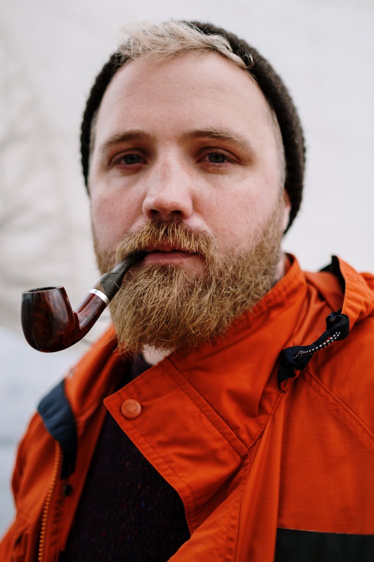 A Man Smoking Using A Tobacco Pipe