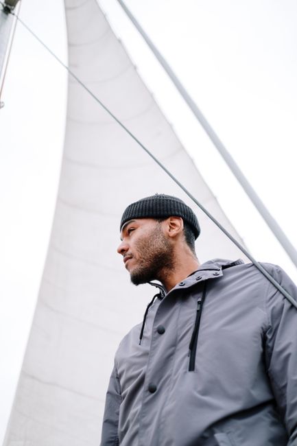 A man enjoying a peaceful sailing journey, embodying leisure and adventure at sea.