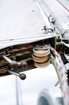 Detailed view of a sailboat pulley system with ropes highlighting marine mechanism.