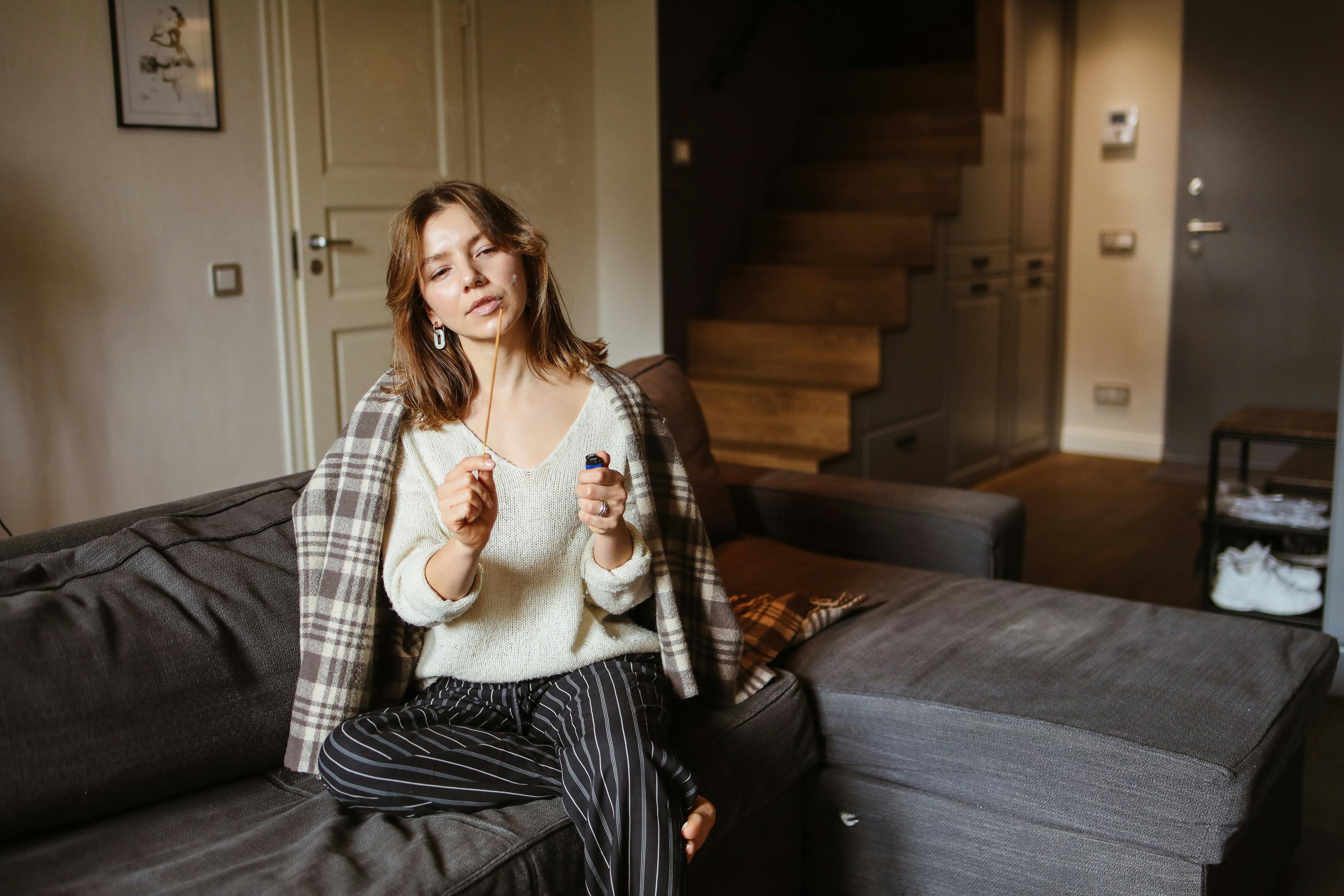 woman sitting with candle on couch