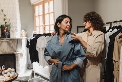 Frau In Blue Denim Button Up Jacke, Die Neben Frau Im Braunen Mantel Steht