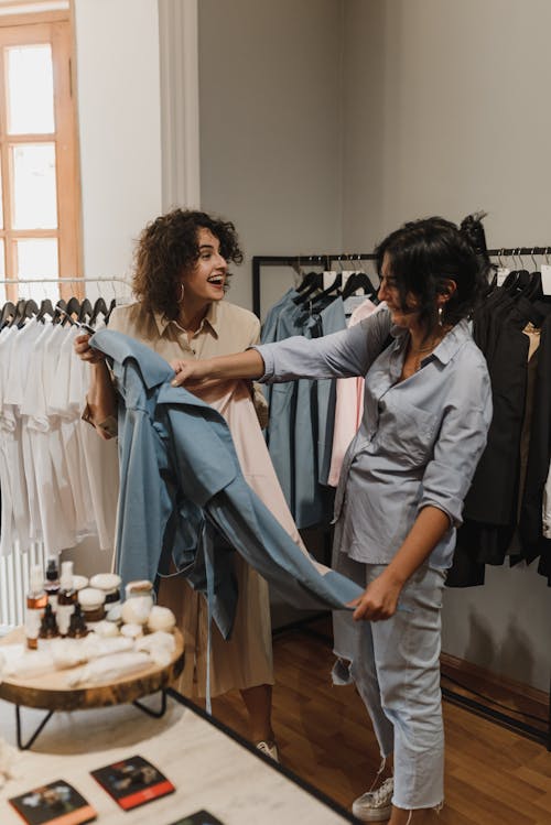 Saleswoman in a Boutique Showing Off a Blue Jacket