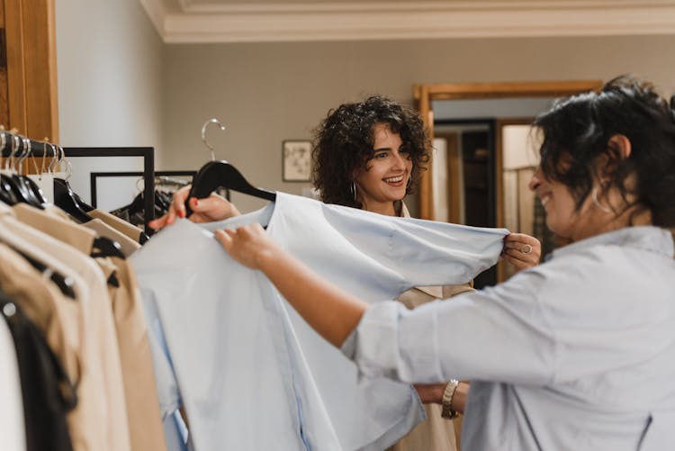 Woman Holding Clothes With Black Hanger