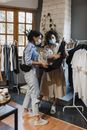 疫情期间，两名戴口罩的妇女在一家精品店买衣服