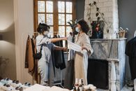 Women Looking at an Outfit at a Fashion Boutique