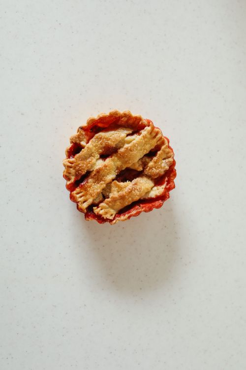 Free A mouth-watering mini cherry pie with lattice crust on a white background. Stock Photo