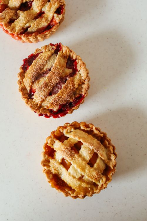 Free Delicious mini cherry pies with lattice crusts, shot in warm lighting from above. Stock Photo
