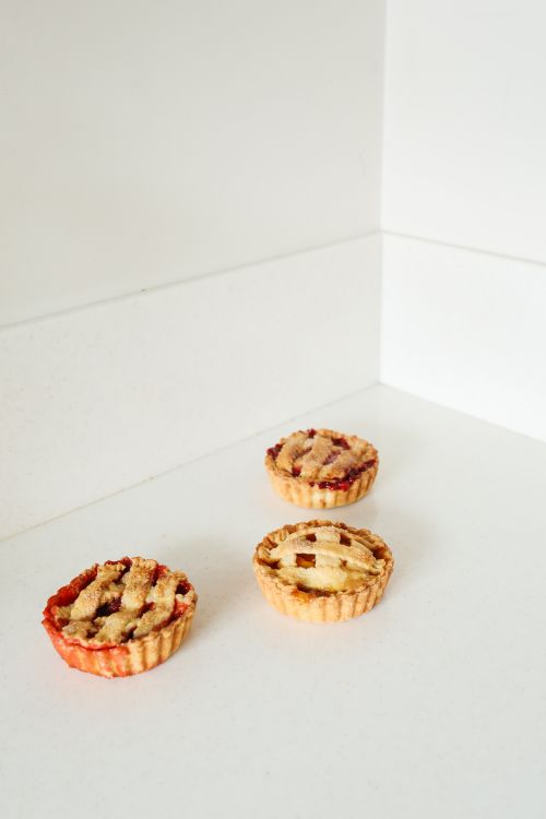 Free Three homemade cherry pies on a white surface, showcasing traditional lattice crusts. Stock Photo