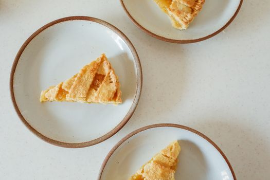 Delicious slices of lemon pie on ceramic plates, captured in an overhead shot.