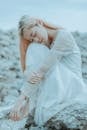 Calm woman with closed eyes sitting on rocks