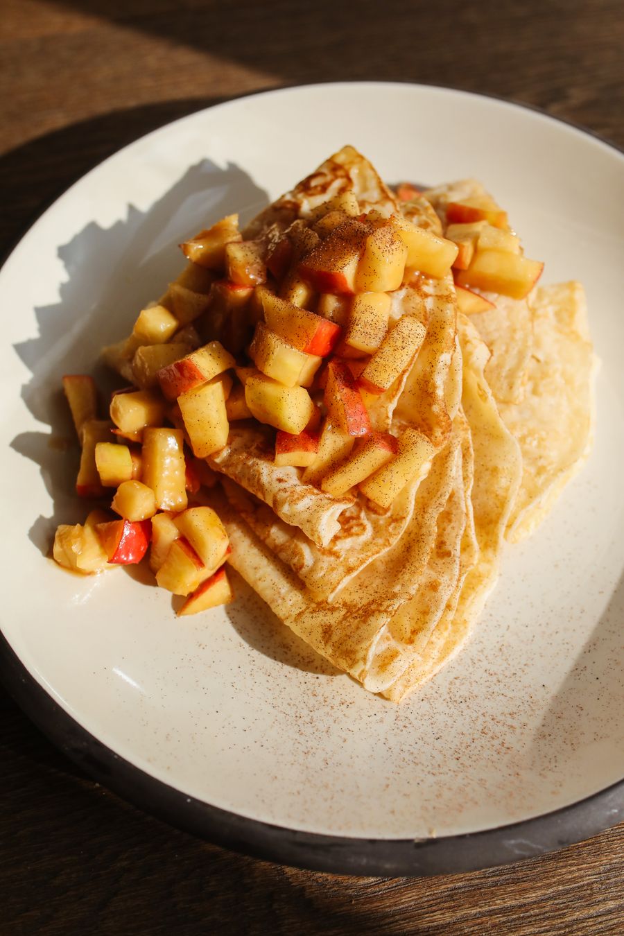 Folded crêpes with caramelised apples in warm light