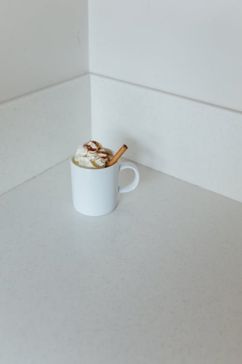 Mug of Whipped Cream with Cinnamon in the Corner of the Kitchen Counter