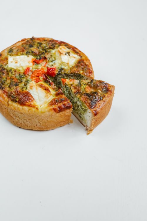 Free High-quality image of a tasty spinach and cheese quiche, perfect for food photography and culinary inspiration. Stock Photo