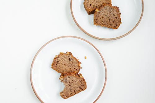 Free Brown Breads on White Ceramic Plates Stock Photo