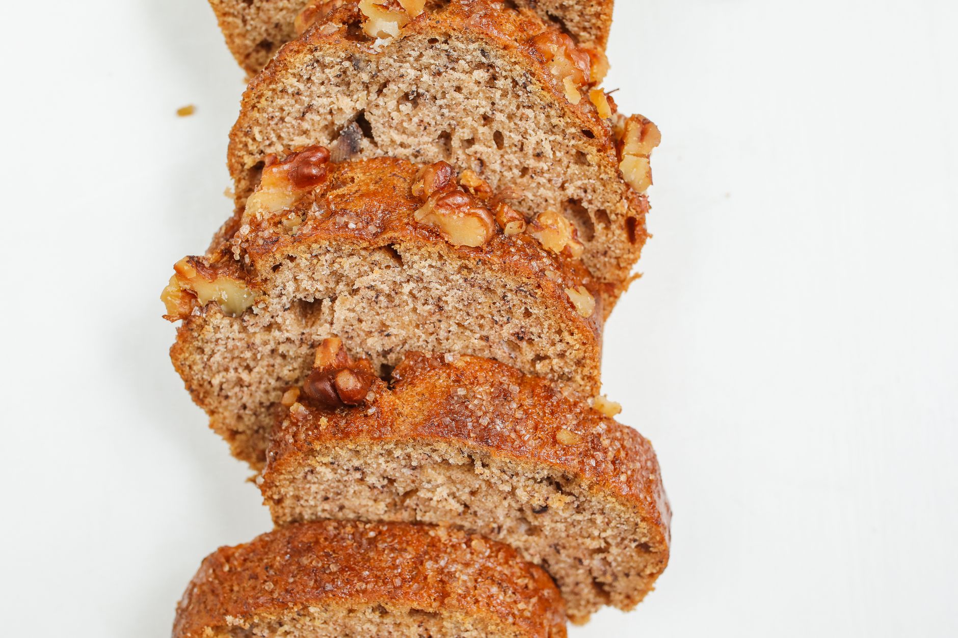Mini whole wheat banana breads with chocolate chips cooling on a rack
