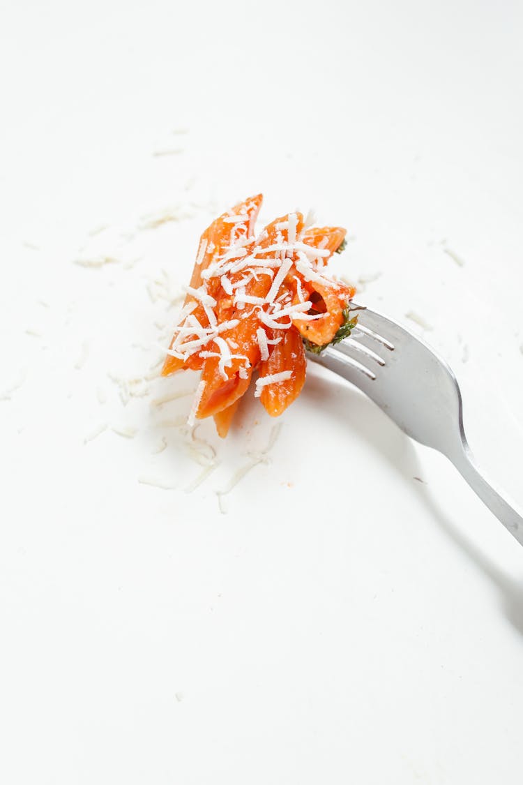 Orange Penne Pasta On Stainless Steel Fork