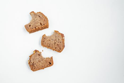 Three delicious banana bread slices arranged on a clean white background, perfect for food photography.
