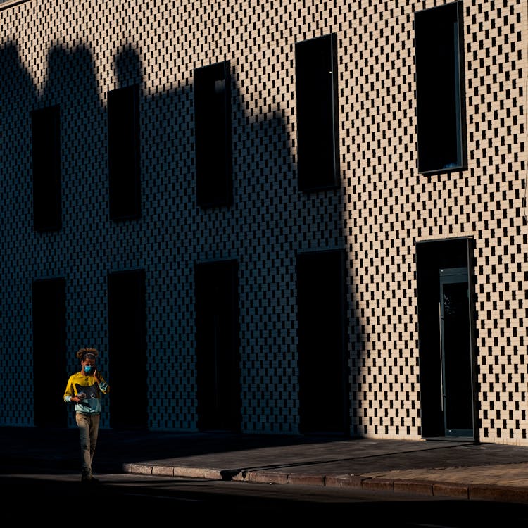 Man Walking Through Empty Street