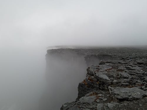 Free Dark Cliff Covered with Fog  Stock Photo