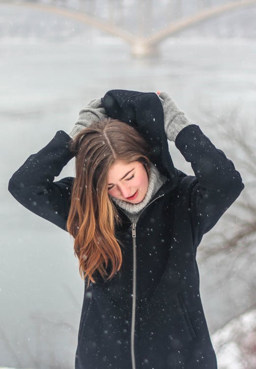 Woman Grabbing the Hood of Her Hoodie