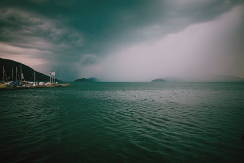 Free Rainy coast with rippling water and pier Stock Photo