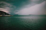 Rainy coast with rippling water and pier