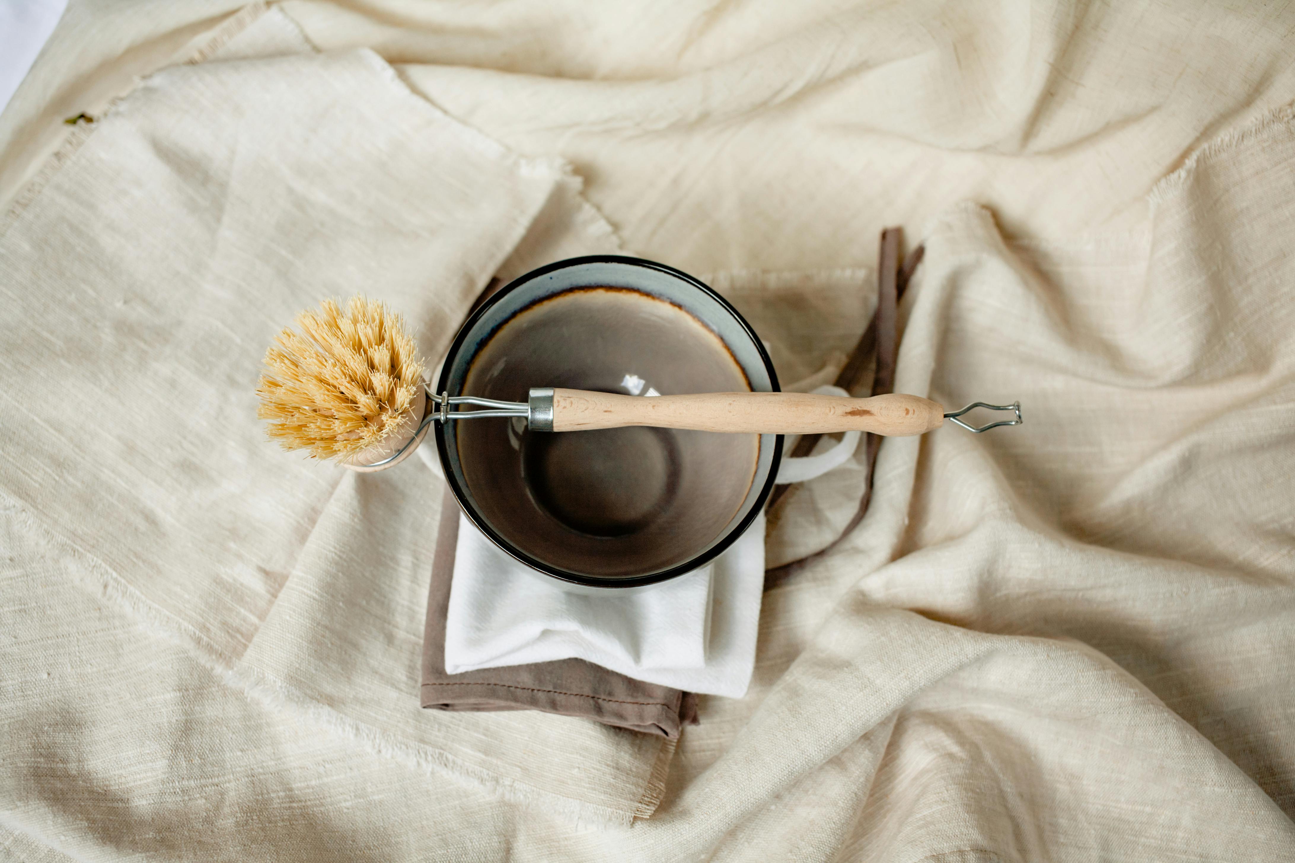 plastic free kitchen swaps with natural wood surfaces and glass containers