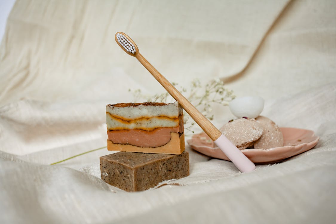 A Wooden Toothbrush on Bar Soaps