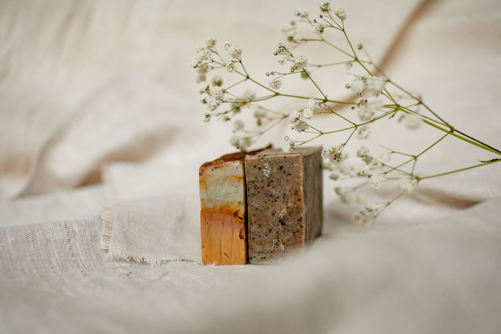 Minimalist flat-lay of artisanal soaps with flowers