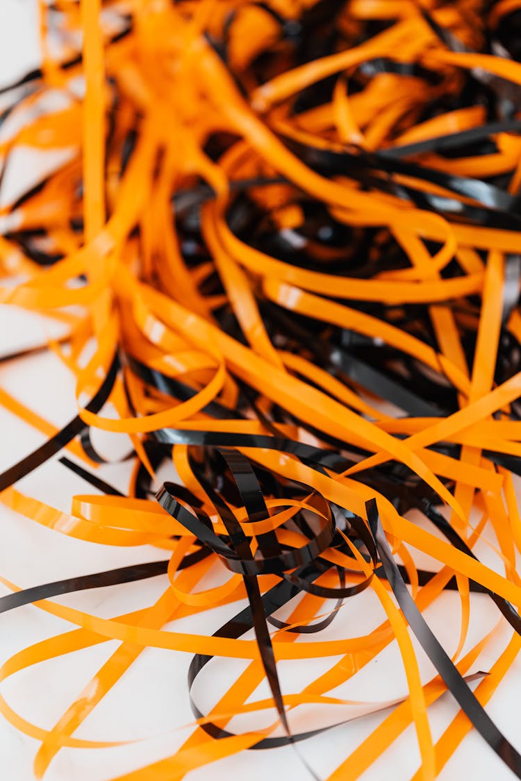 A Black And Orange Plastic Strips On White Surface
