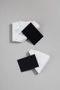 Small Black Pieces of Paper on White Rocks 