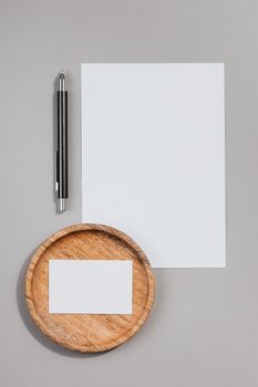 Top view of blank stationery with pen and wooden holder. Ideal for mockups.