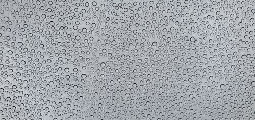Free Artistic image of water droplets forming patterns on a gray background, perfect for design projects. Stock Photo