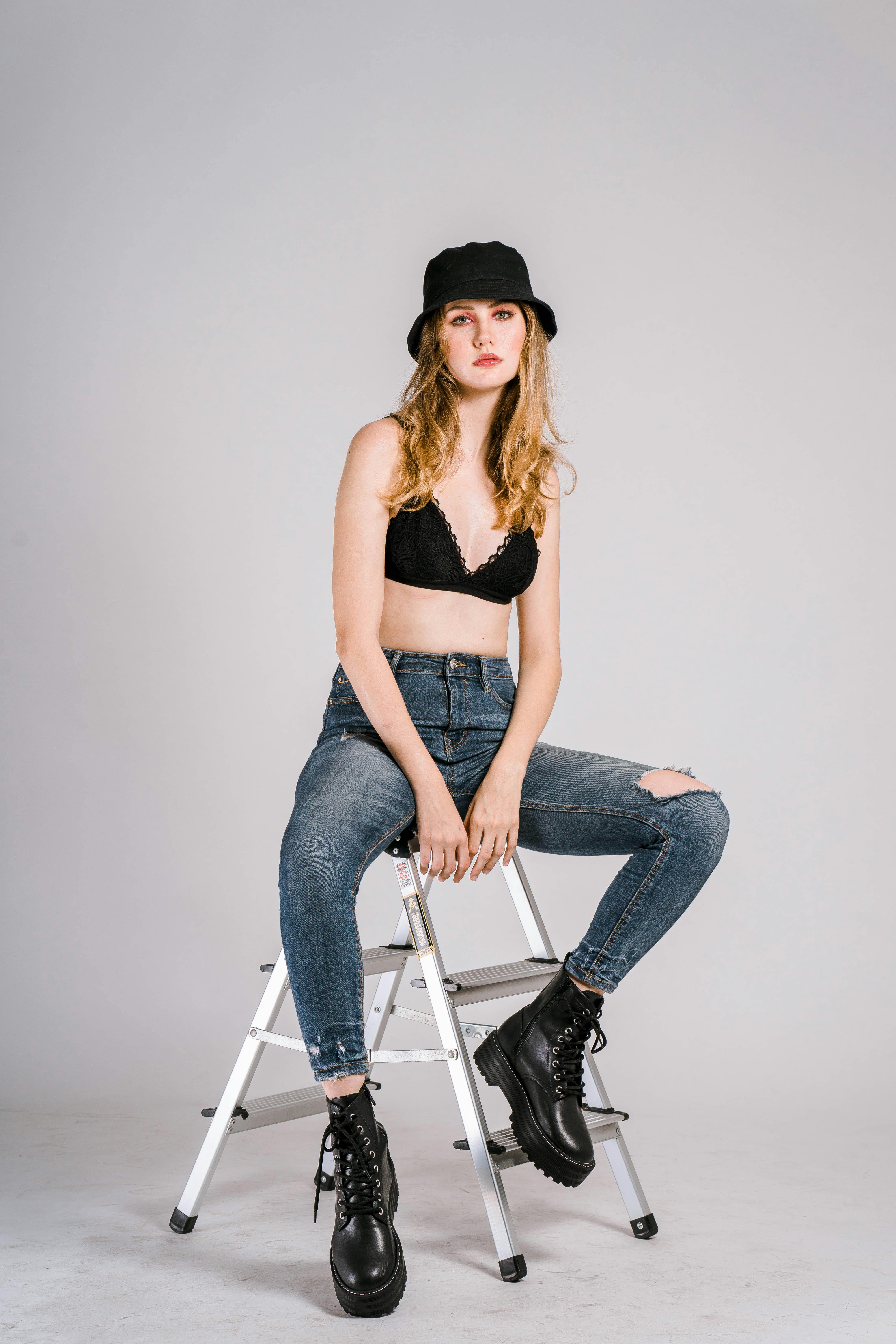 Young woman in bra sitting on ladder \u00b7 Free Stock Photo