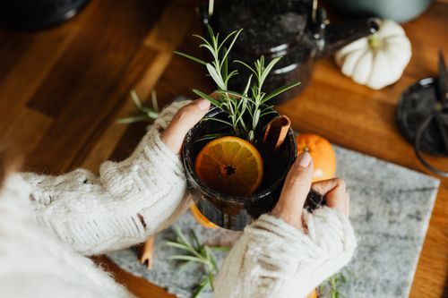 Free Warm cup of herbal tea with citrus and rosemary, perfect for a fall day indoors. Stock Photo